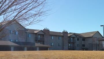 Kearney apartment for rent - a large apartment building on the side of a field