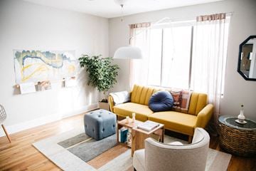 Detroit apartment for rent - a living room with a yellow couch and a table