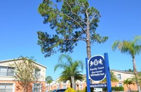 Tampa apartment for rent - A sign for Royalty Court Apartments sits in front of a building.