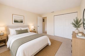 Tampa apartment for rent - A bedroom with a large bed and a painting on the wall.