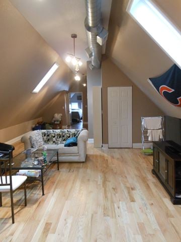 Chicago apartment for rent - a living room with a hard wood floor and a couch and a table