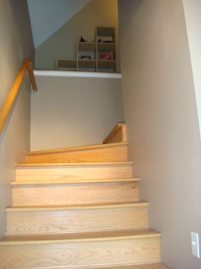 Chicago apartment for rent - a flight of stairs in a home with white walls and wooden railings