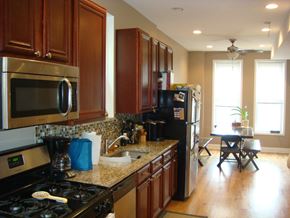 Chicago apartment for rent - a kitchen with stainless steel appliances and wooden cabinets