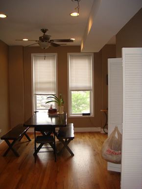 Chicago apartment for rent - a dining room with a table and chairs and two windows
