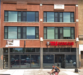 Chicago apartment for rent - a man riding a bike in front of a building