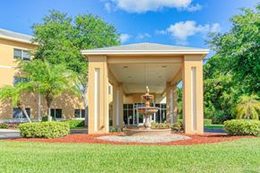 Port St. Lucie apartment for rent - lushly landscaped entrance with tiered fountain