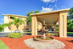 Port St. Lucie apartment for rent - covered drive with tiered fountain and neat landscaping