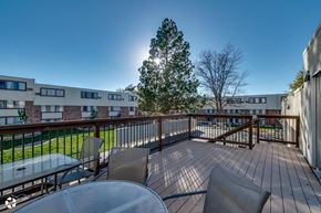 Pueblo apartment for rent - a patio with a table and chairs on a balcony