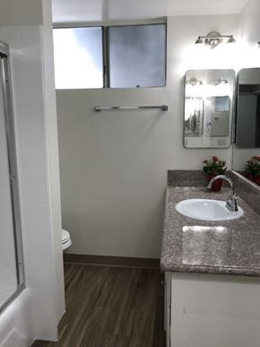 Whittier apartment for rent - A bathroom with a sink, mirror, and toilet.