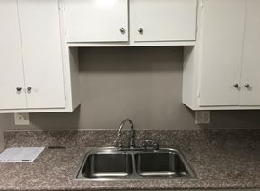 Whittier apartment for rent - A kitchen with a granite countertop and a double sink.