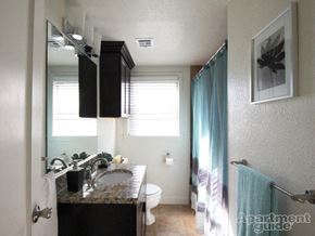 Tulsa apartment for rent - a bathroom with a sink and a toilet and a mirror