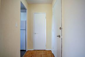Scarborough apartment for rent - an empty room with a refrigerator and a door