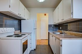 Scarborough apartment for rent - an empty kitchen with white appliances and white cabinets