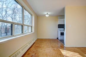 Scarborough apartment for rent - an empty living room with large windows and a wood floor