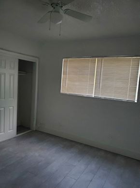 North Miami Beach apartment for rent - A room with a ceiling fan and a window with blinds.