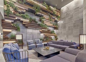 Hoboken apartment for rent - A modern living room with a grey couch and a glass table.