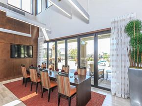 Lenexa apartment for rent - a dining room with a table and chairs and sliding glass doors