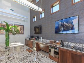 Lenexa apartment for rent - the kitchen has granite counter tops and a large tv