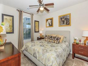 Lenexa apartment for rent - a bedroom with a bed and a ceiling fan
