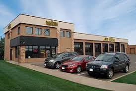 Woodbury apartment for rent - A building with cars parked in front of it.