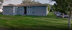 Billings apartment for rent - a blue house with a parking lot of cars