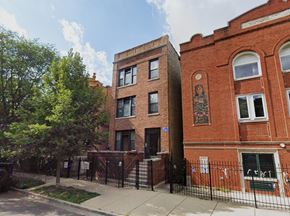 Chicago apartment for rent - the facade of a brick building with a mural on the side