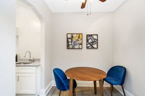Washington apartment for rent - a dining area with a wooden table and two blue chairs
