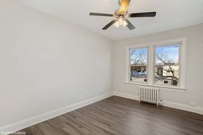 Washington apartment for rent - a bedroom with a ceiling fan and a window