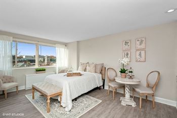 A bedroom with a large bed and a large window