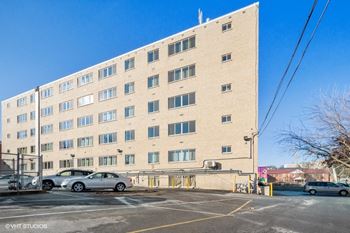 A large brick building with cars parked in front of it
