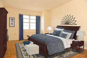 Trenton apartment for rent - A bedroom with a large bed and a wooden headboard.
