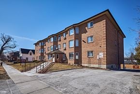 Oshawa apartment for rent - a brick apartment building with stairs and a driveway
