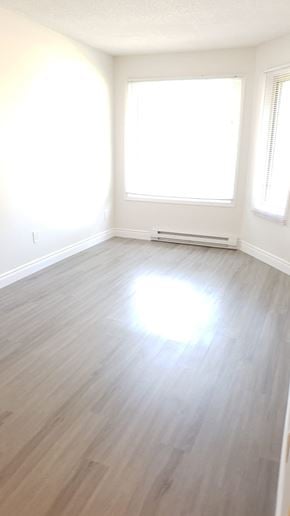 Oshawa apartment for rent - an empty room with a hard wood floor