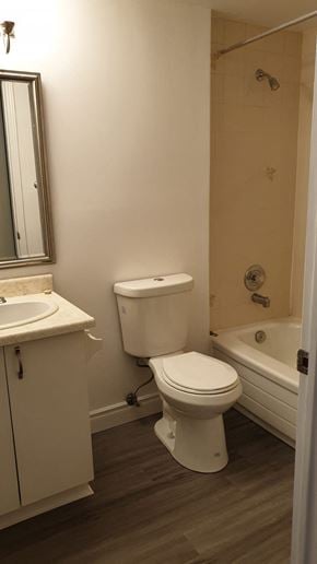 Oshawa apartment for rent - a bathroom with a toilet and a sink