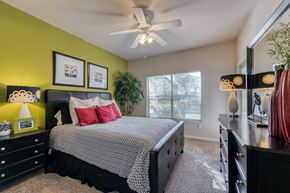 Dallas apartment for rent - a bedroom with a bed and a ceiling fan
