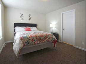 Watford City apartment for rent - a bedroom with a bed and a door to a closet