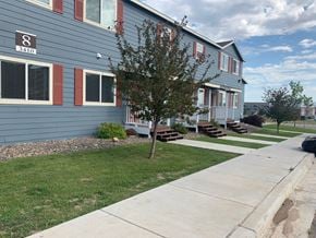 Watford City apartment for rent - a blue house with a sidewalk in front of it