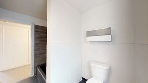 Ottawa apartment for rent - a white bathroom with a toilet and a window