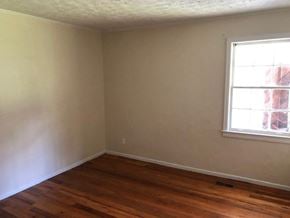 Talladega house for rent - an empty room with a window and wooden floors