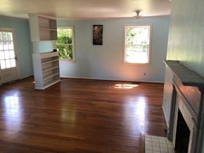 Talladega house for rent - a living room with a hard wood floor and a fireplace