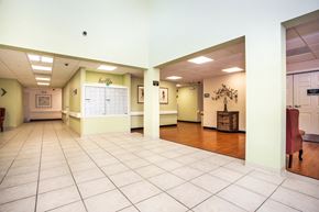 Fort Myers apartment for rent - lobby of Villa Vincente with tile & wood-style floor and mailbox bank in wall