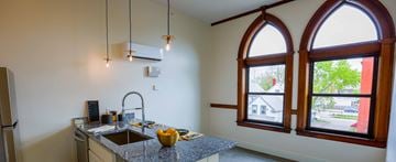 Cleveland apartment for rent - a kitchen with large arched windows and a granite counter top