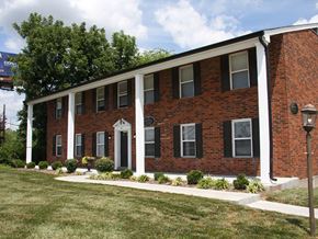 Saint Charles apartment for rent - a red brick building with white columns and a lawn