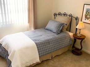 O'fallon apartment for rent - a bedroom with a bed and a table with a lamp