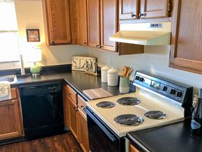 Saints Charles townhouse for rent - a kitchen with a stove top oven and a sink