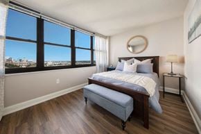St. Louis apartment for rent - a bedroom with a large window and a bed