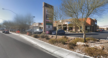 Las Vegas apartment for rent - a city street with cars parked in front of a building