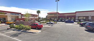 Las Vegas apartment for rent - A parking lot with cars and a building in the background.