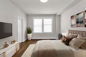 San Francisco apartment for rent - A bedroom with a large bed and a television on the wall.