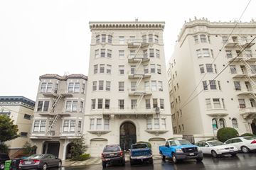 San Francisco apartment for rent - A row of old buildings with cars parked in front.